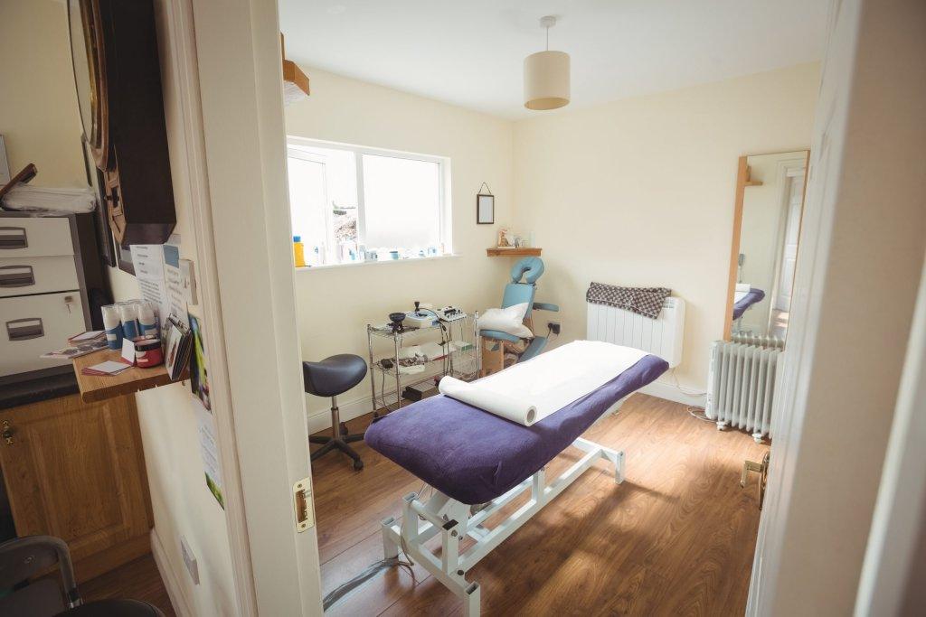 Examination bed in dry needling clinic interior