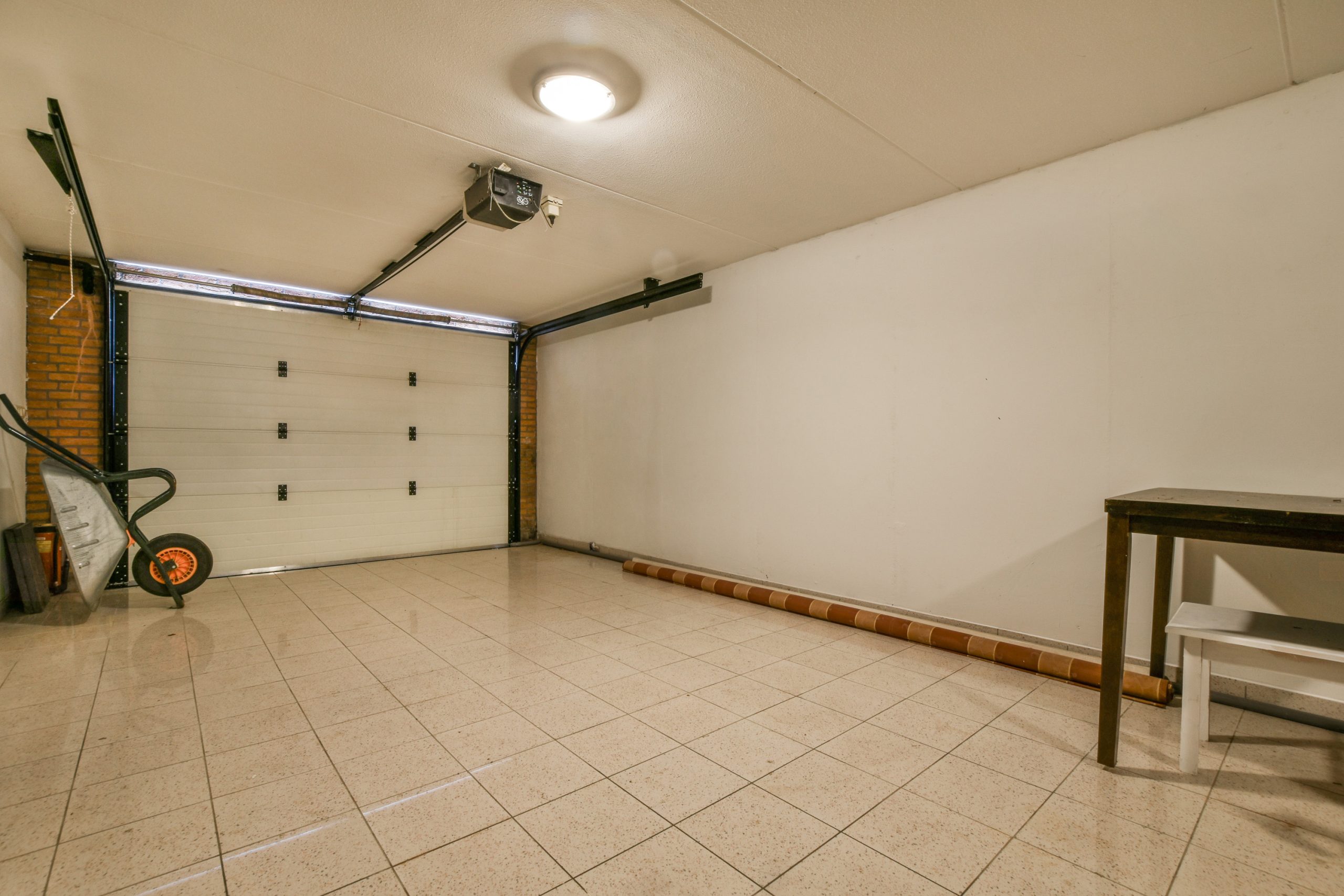 a room with a white wall and a garage door