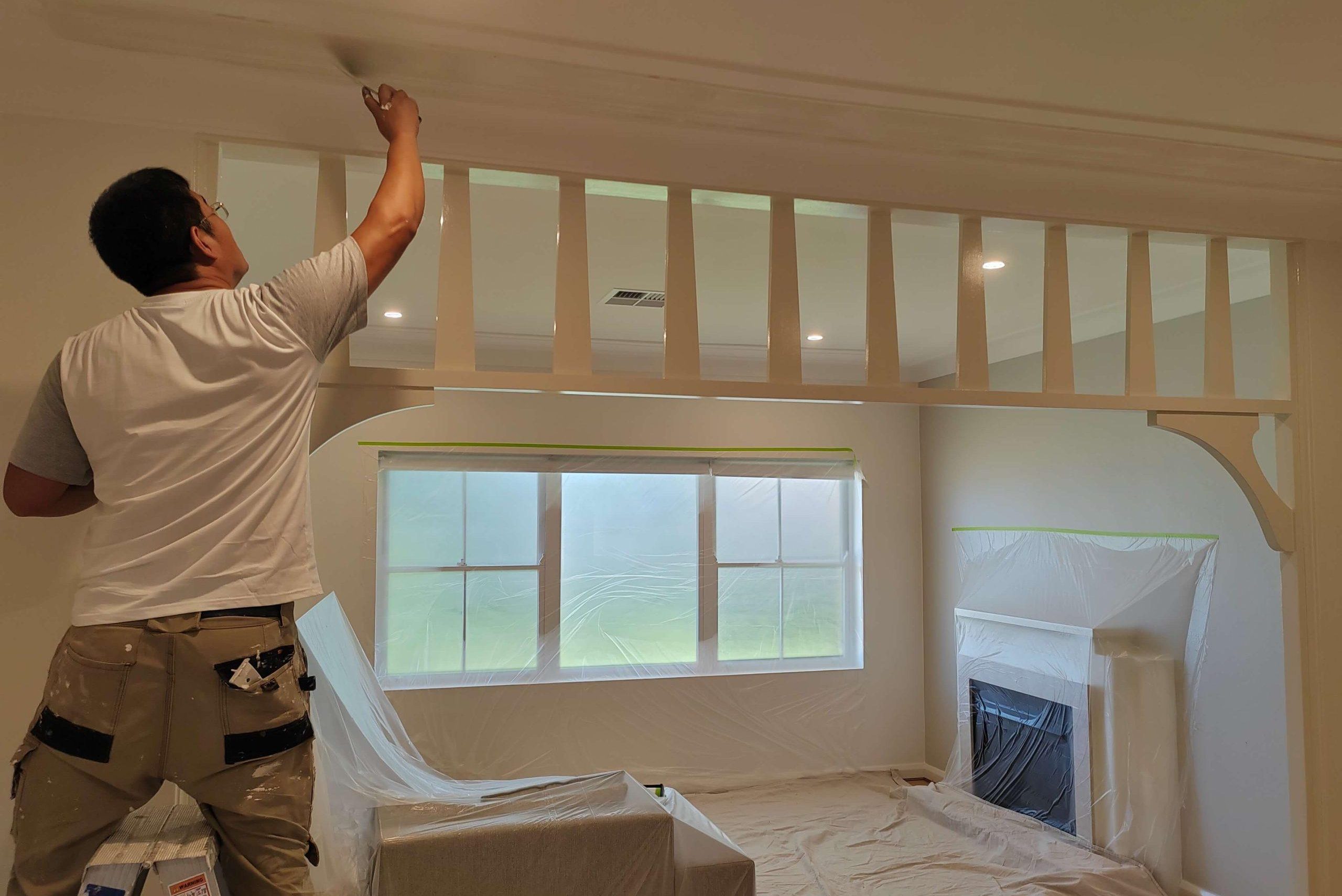 Painter working on the ceiling in a residential room